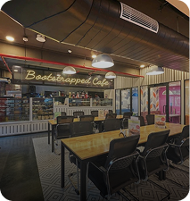 5-seater workspace near the café with wooden tables and comfortable seating